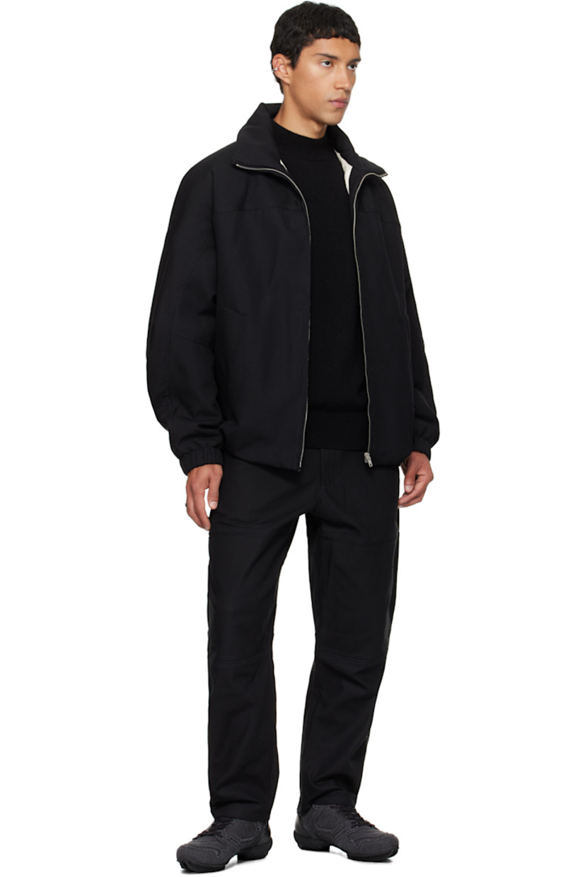 Padded virgin wool twill jacket.

· Stand collar
· Zip closure
· Press-stud welt pockets at waist
· Partially elasticized hem
· Yoke sleeves
· Elasticized cuffs
· Striped webbing strap at back collar
· Full satin twill lining

Supplier color: Black