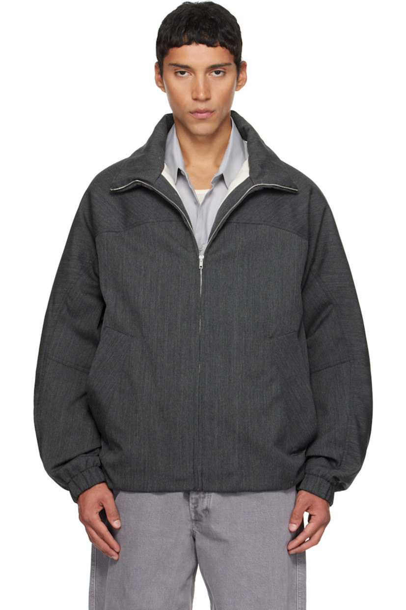 Padded virgin wool twill jacket.

· Stand collar
· Zip closure
· Press-stud welt pockets at waist
· Partially elasticized hem
· Yoke sleeves
· Elasticized cuffs
· Striped webbing strap at back collar
· Full satin twill lining

Supplier color: Concrete