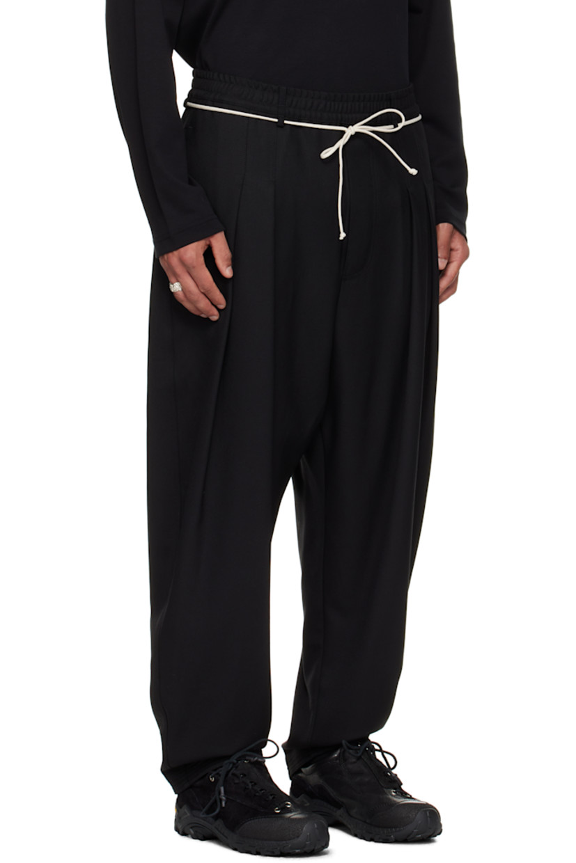 Virgin wool barathea trousers.

· Belt loops at elasticized waistband
· Two-pocket styling
· Mock fly
· Drawstring at waist
· Pleats at front
· Topstitching at cuffs
· Stripes printed at back leg

Supplier color: Black
