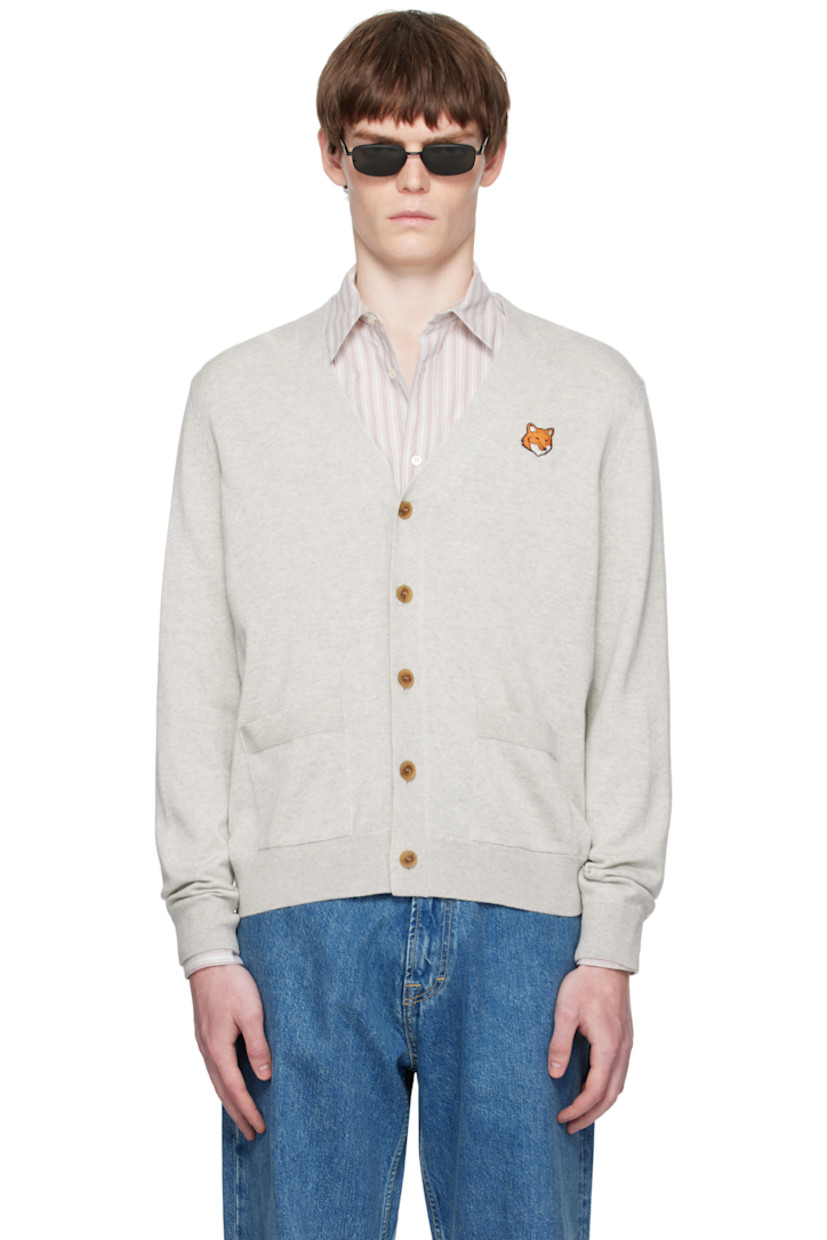 Knit wool cardigan.

· Rib-knit Y-neck, hem, and cuffs
· Button closure
· Embroidered logo patch at chest
· Patch pockets at front

Supplier color: Light grey melange