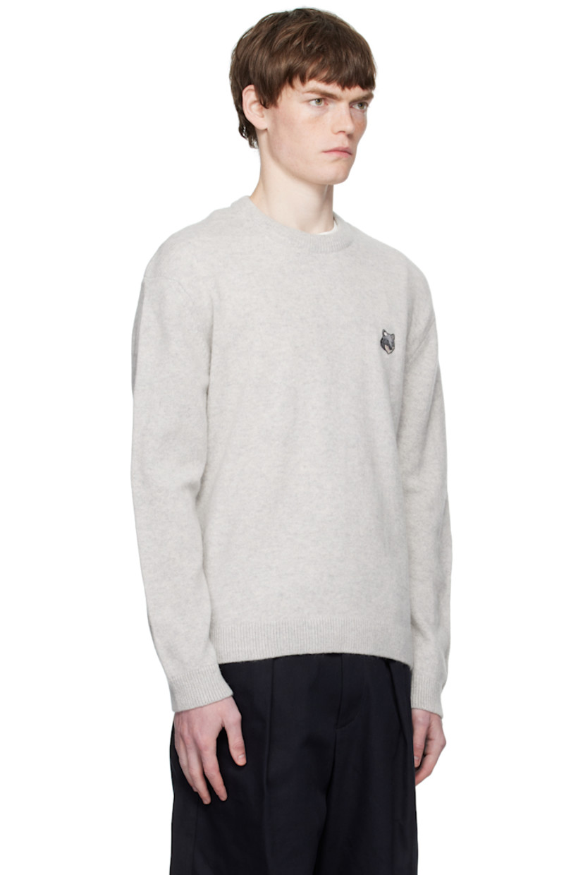 Knit wool sweater.

· Rib-knit crewneck, hem, and cuffs
· Embroidered logo patch at chest
· Dropped shoulders

Supplier color: Light grey melange