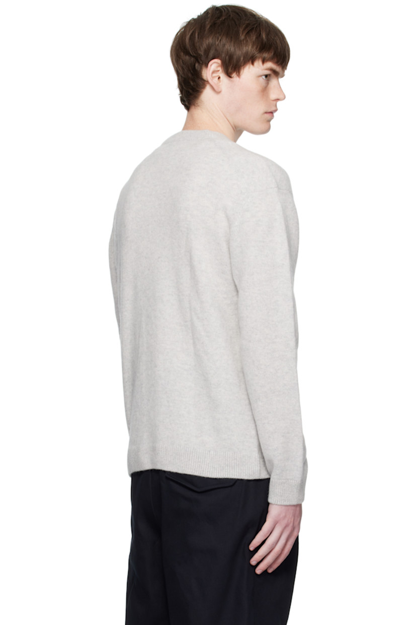 Knit wool sweater.

· Rib-knit crewneck, hem, and cuffs
· Embroidered logo patch at chest
· Dropped shoulders

Supplier color: Light grey melange
