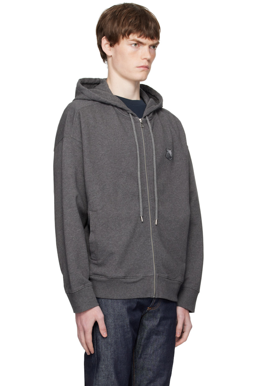 Cotton french terry hoodie.

· Drawstring at hood
· Zip closure
· Logo patch embroidered at chest 
· Welt pockets at waist 
· Rib-knit hem and cuffs
· Logo-engraved silver-tone hardware

Supplier color: Dark Grey Melange
