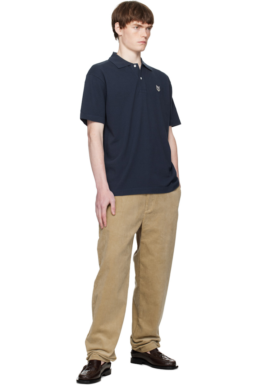 Cotton piqué polo. 

· Rib-knit spread collar
· Two-button placket
· Logo patch embroidered at chest
· Tennis-tail hem

Supplier color: Classic Navy