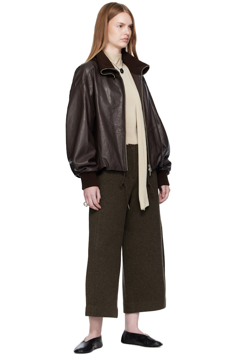Knit wool-blend trousers.

· Two-pocket styling
· Zip fly
· Mock pockets at back
· Central crease at back legs

Supplier color: Dark olive