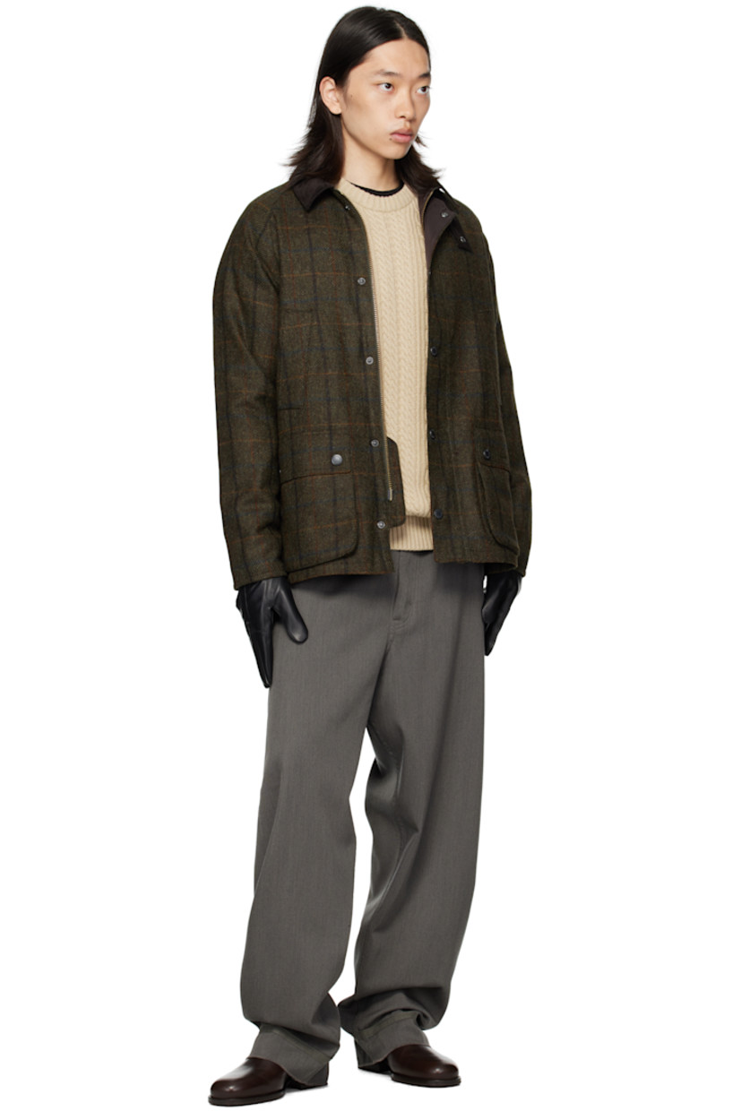 Insulated wool melton jacket.

· Check pattern throughout
· Rivets at corduroy spread collar
· Press-stud throat guard
· Zip closure with press-stud placket
· Welt pockets and flap pockets at front
· Logo embroidered at front
· Raglan sleeves
· Metal eyelets at underarms
· Press-stud expansion panels at back hem
· Patch pocket at interior
· Full quilted satin lining

Supplier color: Brown