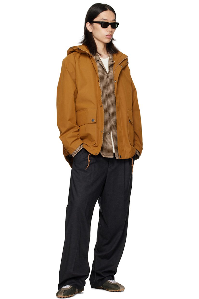 Coated canvas jacket.

· Waterproof
· Bungee-style drawstring at detachable hood
· Stand collar
· Two-way zip closure with press-stud placket
· Flap pockets and embroidered logo at front
· Cord-lock drawstring at hem
· Raglan sleeves
· Metal eyelets at underarms
· Adjustable button tab at cuffs
· Locker loop at back collar
· Patch pocket at interior
· Full satin and flannel lining

Supplier color: Bronze brown