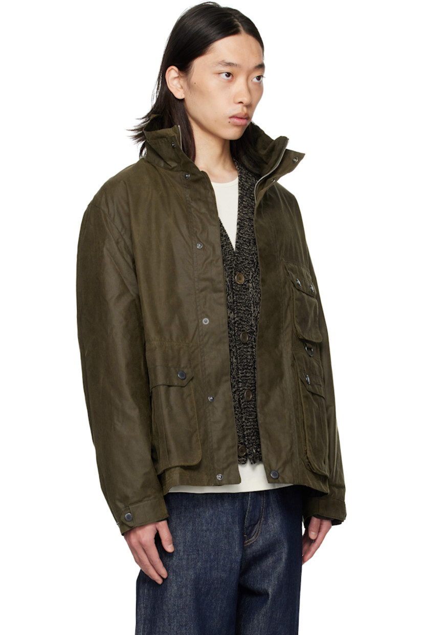 Waxed cotton canvas jacket. 

· Stand collar 
· Concealed two-way zip closure
· Press-stud placket 
· Flap pockets, D-ring, and logo embroidered at front
· Grommets at side seams
· Press-stud cuffs
· Cinch tabs at back hem 
· Patch pocket at interior 
· Partial twill lining

Supplier color: Beech