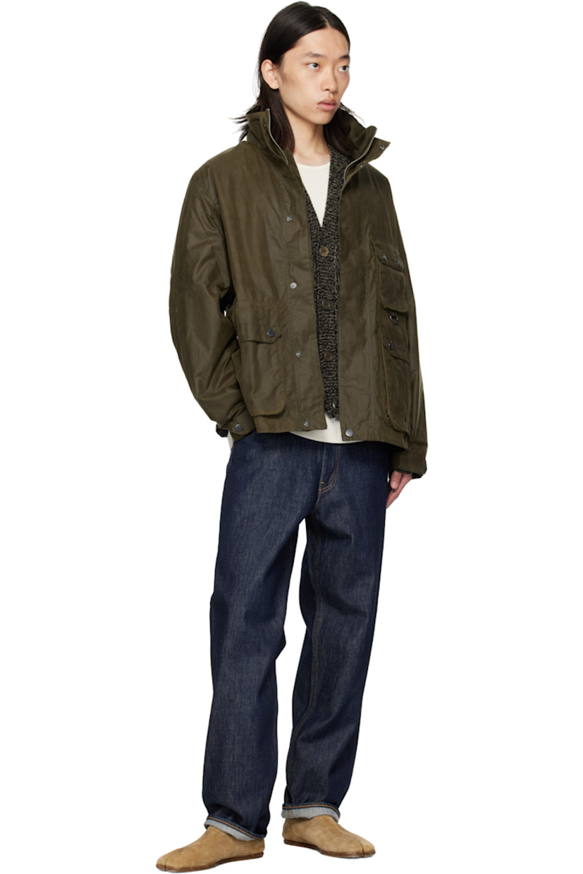 Waxed cotton canvas jacket. 

· Stand collar 
· Concealed two-way zip closure
· Press-stud placket 
· Flap pockets, D-ring, and logo embroidered at front
· Grommets at side seams
· Press-stud cuffs
· Cinch tabs at back hem 
· Patch pocket at interior 
· Partial twill lining

Supplier color: Beech