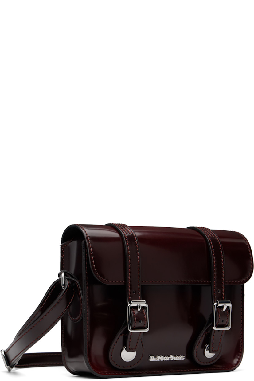 Polished faux-leather shoulder bag.

· Adjustable crossbody strap
· Logo hardware at face
· Pin-buckle tabs at magnetic press-stud flap
· Twill lining
· Logo-engraved silver-tone hardware
· H5" x W7" x D2"

Supplier color: Cherry red