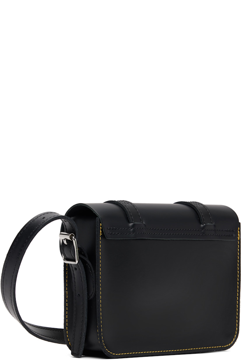 Buffed leather shoulder bag.

· Adjustable crossbody strap
· Logo hardware at face
· Mock buckles at magnetic press-stud flap
· Suede lining
· Contrast stitching in yellow
· H5.5" x W7" x D2"

Supplier color: Black smooth leather