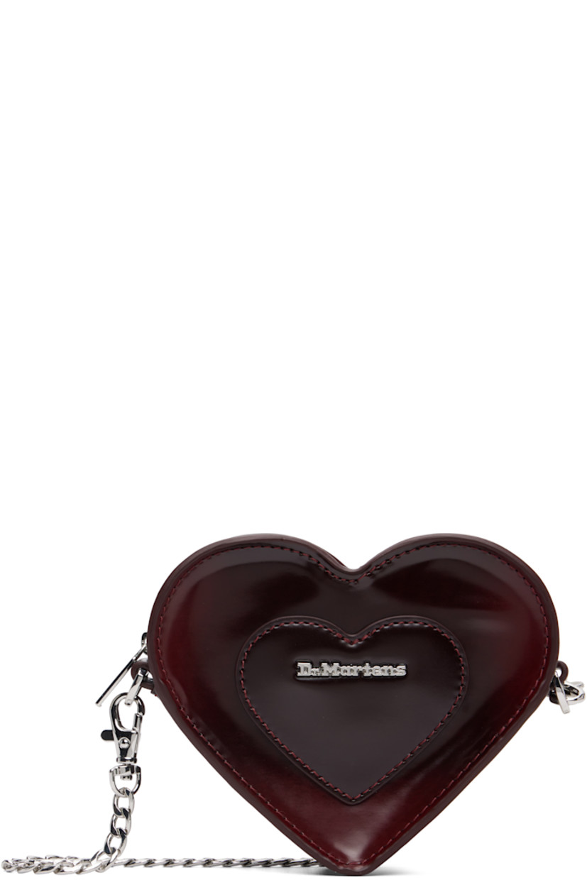 Heart-shaped buffed faux-leather shoulder bag.

· Adjustable and detachable crossbody strap
· Alternate detachable crossbody chain
· Logo hardware and graphic appliqué at face
· Zip closure
· Card slot at interior
· Twill lining
· H4.5" x W6" x D1.5"

Supplier color: Oxford rub off