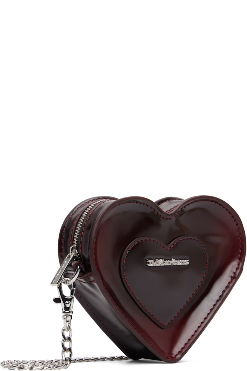 Heart-shaped buffed faux-leather shoulder bag.

· Adjustable and detachable crossbody strap
· Alternate detachable crossbody chain
· Logo hardware and graphic appliqué at face
· Zip closure
· Card slot at interior
· Twill lining
· H4.5" x W6" x D1.5"

Supplier color: Oxford rub off