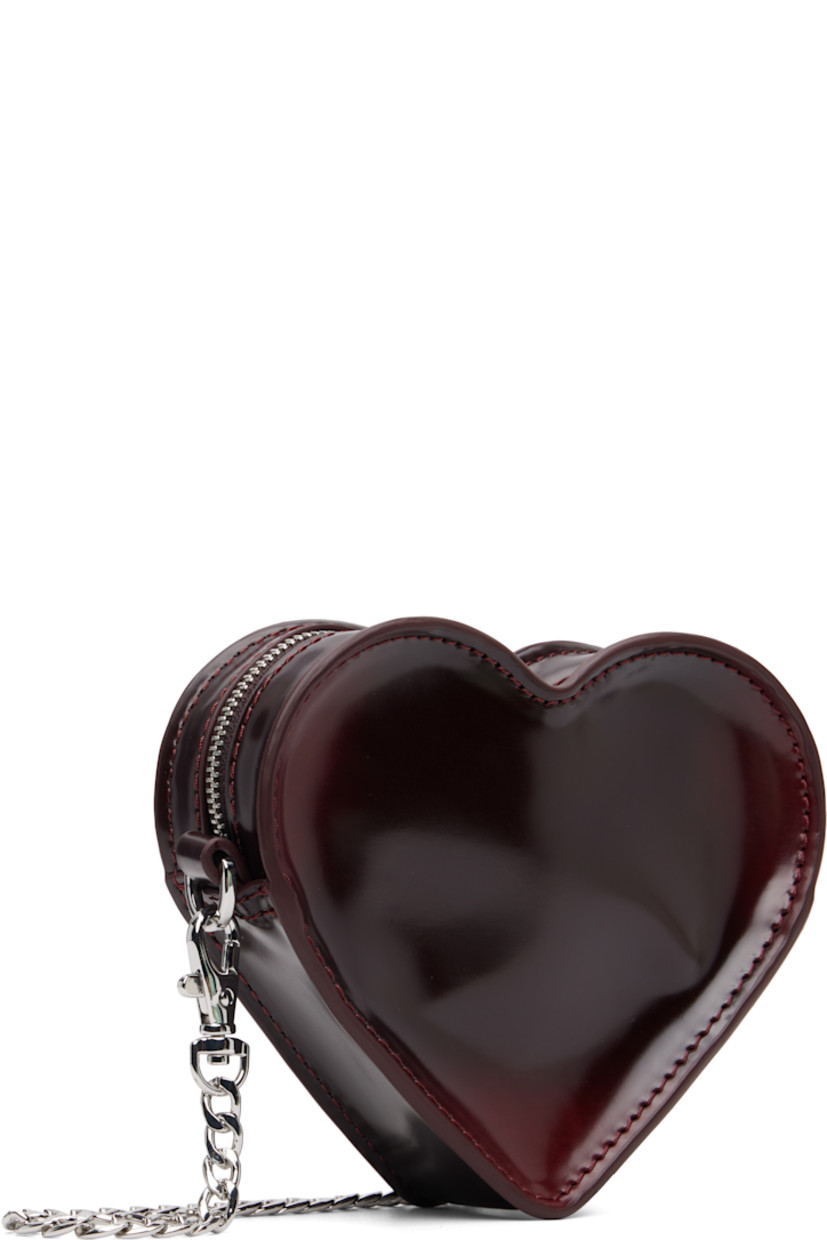 Heart-shaped buffed faux-leather shoulder bag.

· Adjustable and detachable crossbody strap
· Alternate detachable crossbody chain
· Logo hardware and graphic appliqué at face
· Zip closure
· Card slot at interior
· Twill lining
· H4.5" x W6" x D1.5"

Supplier color: Oxford rub off