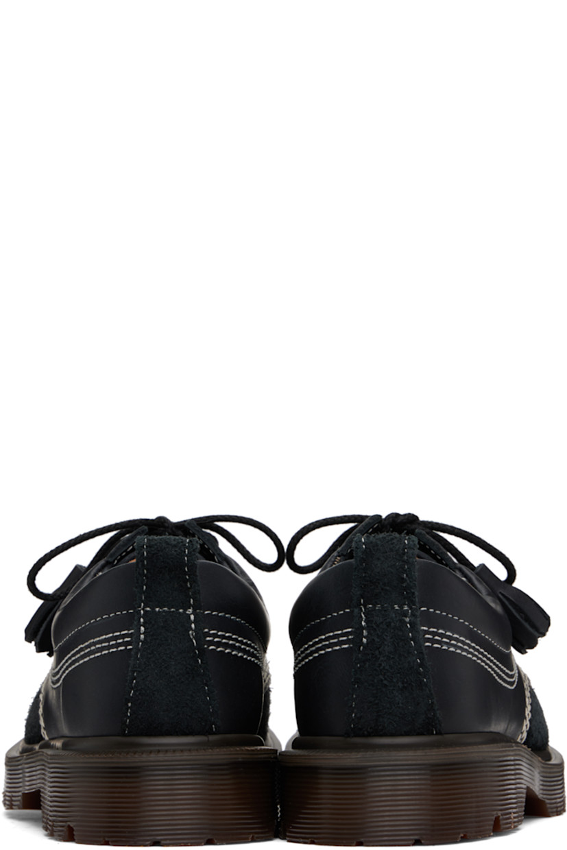 Buffed leather, nubuck, and suede derbys in black.

· Blanket stitching at moc toe
· Tassels at lace-up closure
· Padded collar
· Pull-loop at heel collar
· Buffed leather and suede lining
· Serrated detailing at heat-sealed Goodyear welt
· Treaded Air Cushion rubber sole
· Contrast stitching in white

Supplier color: Black kinsley tumble