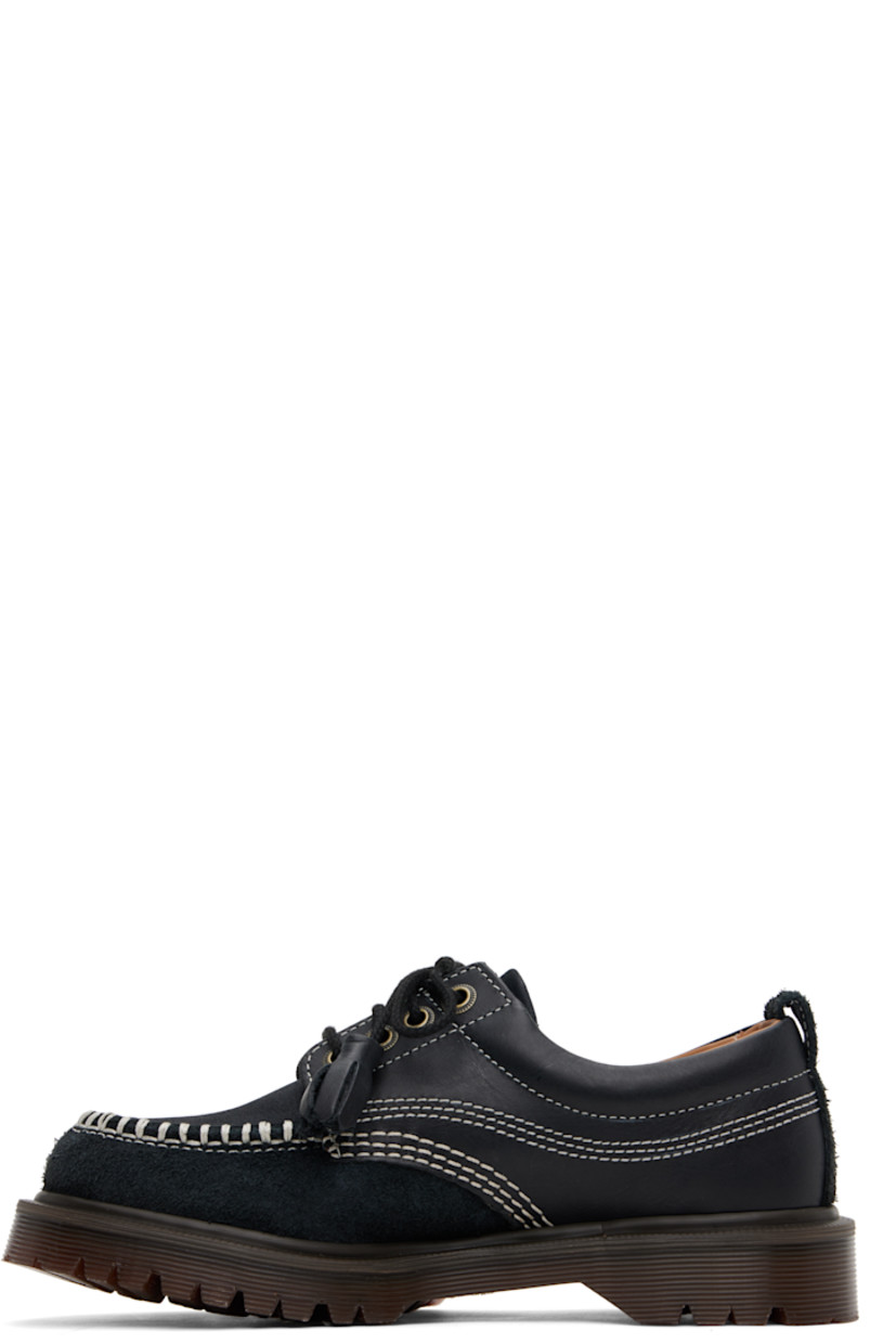 Buffed leather, nubuck, and suede derbys in black.

· Blanket stitching at moc toe
· Tassels at lace-up closure
· Padded collar
· Pull-loop at heel collar
· Buffed leather and suede lining
· Serrated detailing at heat-sealed Goodyear welt
· Treaded Air Cushion rubber sole
· Contrast stitching in white

Supplier color: Black kinsley tumble