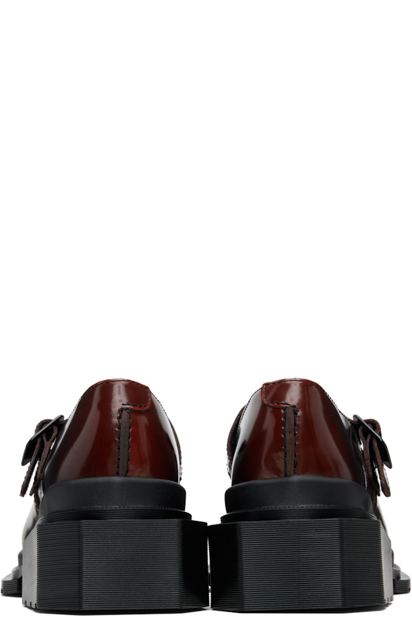 Polished leather Mary Jane-style heels.

· Square toe
· Pin-buckle strap at vamp
· Rubber block heel
· Serrated edge at welt
· Treaded Air Cushion rubber sole
· Heel: H1.75"

Supplier color: Black/Cherry red arcadia