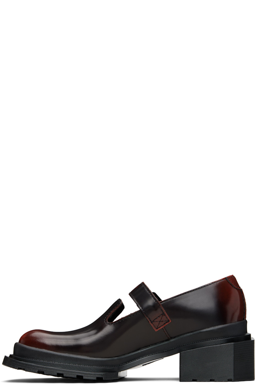 Polished leather Mary Jane-style heels.

· Square toe
· Pin-buckle strap at vamp
· Rubber block heel
· Serrated edge at welt
· Treaded Air Cushion rubber sole
· Heel: H1.75"

Supplier color: Black/Cherry red arcadia