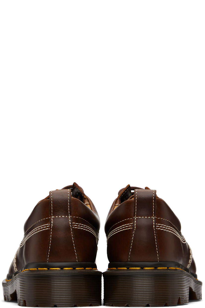 Buffed leather derbys.

· Blanket stitching at moc toe
· Lace-up closure
· Padded collar
· Pull-loop at heel collar
· Buffed leather lining
· Yellow stitching at heat-sealed Goodyear welt
· Treaded Air Cushion rubber sole
· Contrast stitching in off-white

Supplier color: Butterscotch