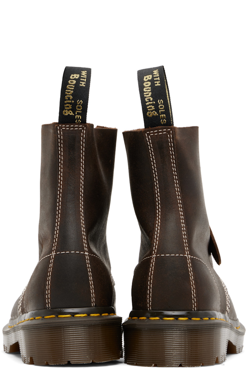 Handcrafted ankle-high waxed buffed leather boots.

· Removable logo tag at lace-up closure
· Jacquard logo-woven pull-loop at heel collar
· Suede lining
· Yellow stitching at heat-sealed Goodyear welt
· Treaded AirWair™ air-cushioned rubber sole
· Contrast stitching in white

Supplier color: Brown/Wax commander