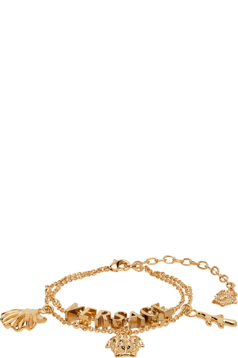 Tiered cable chain bracelet in gold tone. 

·� Logo and graphic charms throughout 
· Medusa charm at adjustable lobster-clasp fastening 
· L9"

Part of the La Vacanza collection.

Supplier color: Light gold