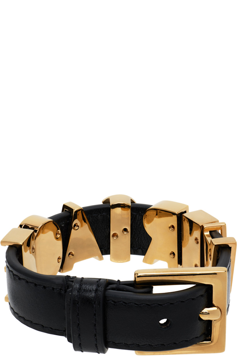 Buffed leather bracelet in black. 

· Logo hardware at length
· Pin-buckle fastening 
· Gold-tone hardware 
· L8.75"

Supplier color: Black/Gold