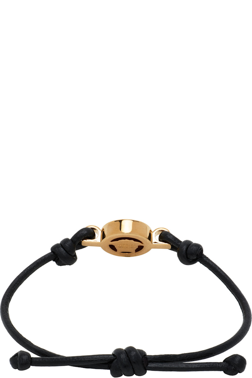 Buffed leather bracelet in black. 

· Medusa hardware at face
· Pull-through fastening 
· Gold-tone hardware 
· D4.5"

Supplier color: Black/Gold