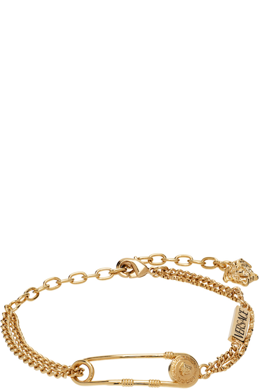 Tiered cable chain, curb chain, and box chain bracelet in gold tone.

· Logo plaque at length
· Medusa-engraved safety-pin hardware
· Logo charm at adjustable lobster-clasp fastening 
· L8.5"

Supplier color: Gold