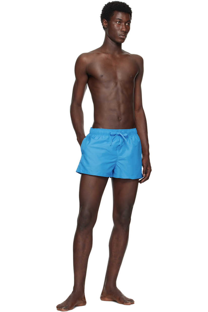 Taffeta swim shorts.

· Drawstring at elasticized waistband
· Three-pocket styling
· Mock fly
· Embroidered Medusa patch at front
· Briefs-style mesh lining
· Includes zip travel pouch

Supplier color: Blue