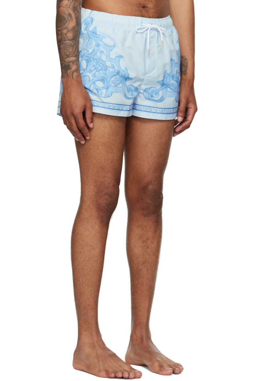Taffeta swim shorts.

· Barocco pattern printed throughout
· Drawstring at elasticized waistband
· Three-pocket styling
· Mock fly
· Mesh brief-style lining
· Logo-engraved gold-tone hardware

Supplier color: Grey/Light blue