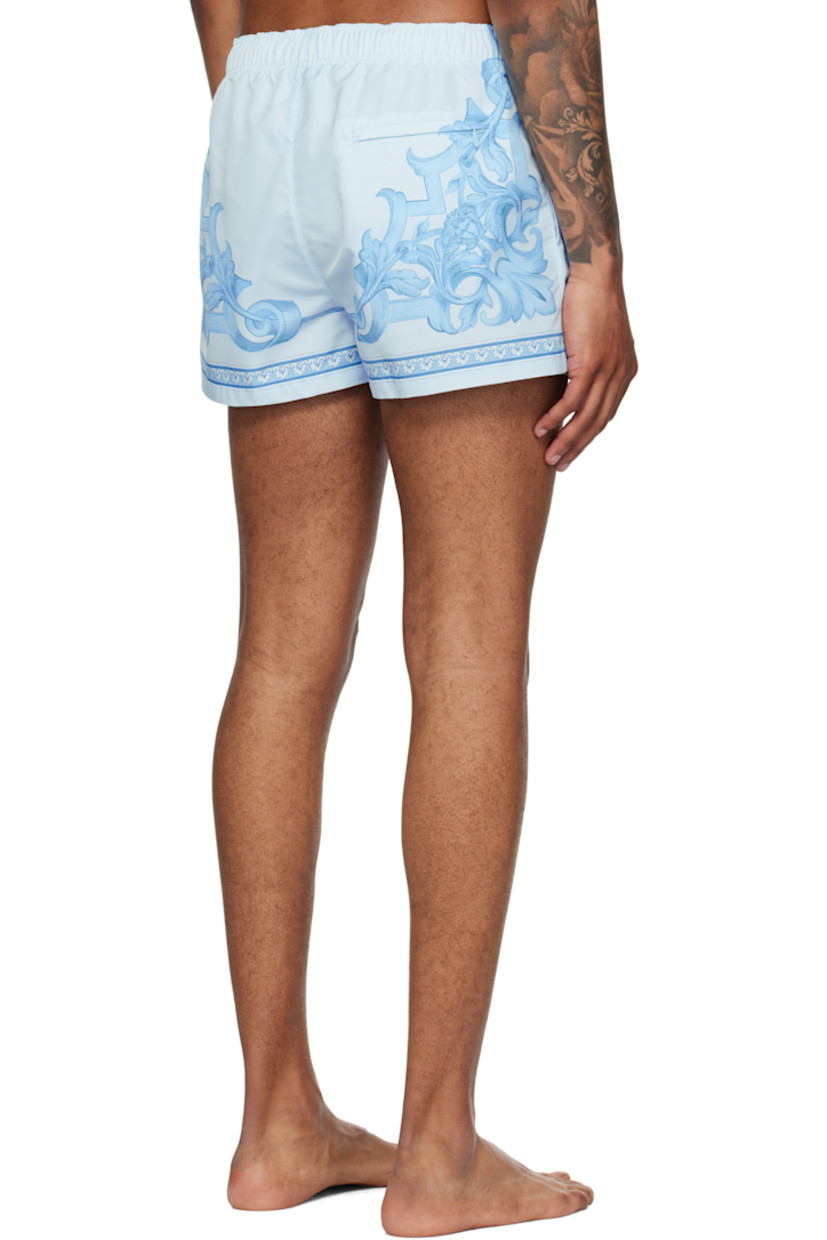 Taffeta swim shorts.

· Barocco pattern printed throughout
· Drawstring at elasticized waistband
· Three-pocket styling
· Mock fly
· Mesh brief-style lining
· Logo-engraved gold-tone hardware

Supplier color: Grey/Light blue