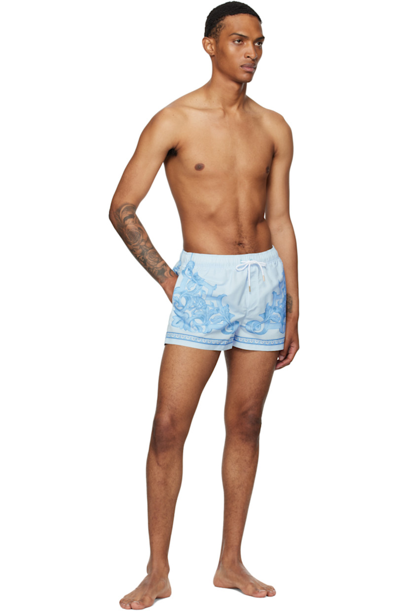 Taffeta swim shorts.

· Barocco pattern printed throughout
· Drawstring at elasticized waistband
· Three-pocket styling
· Mock fly
· Mesh brief-style lining
· Logo-engraved gold-tone hardware

Supplier color: Grey/Light blue
