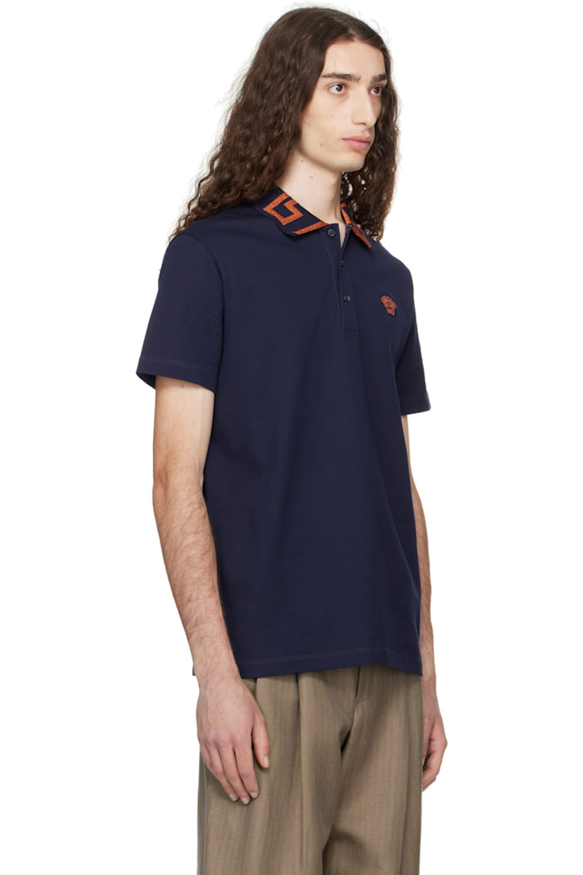 Cotton piqué polo.

· Rib-knit spread collar
· Glittered jacquard Greek key pattern at collar 
· Three-button placket 
· Medusa embroidered at chest 

Part of the La Vacanza collection.

Supplier color: Navy