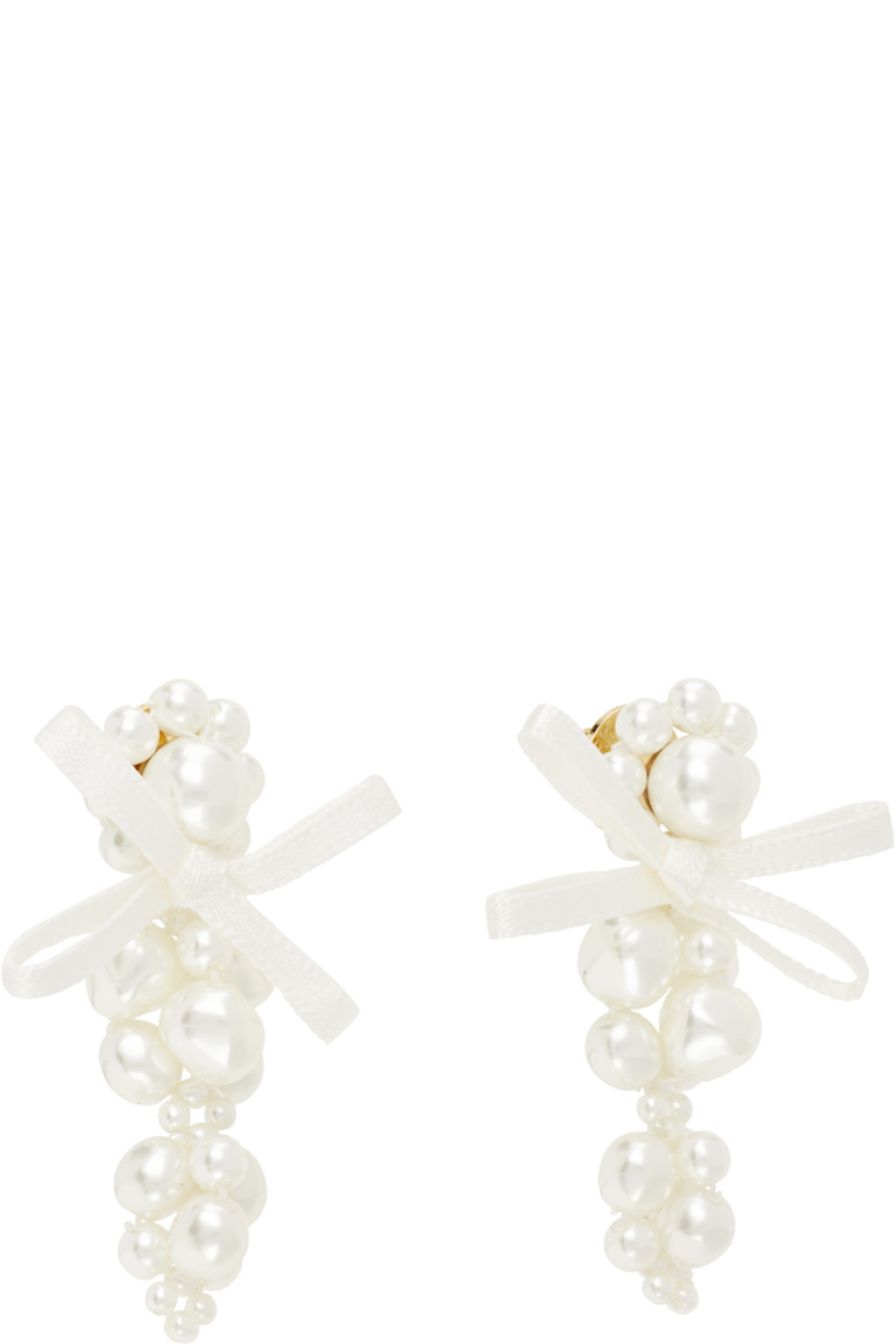 Pair of beaded faux-pearl drop earrings.

· Bow appliqué at face
· Post-stud fastening
· Gold-tone brass hardware
· H2" x W1"

Supplier color: Pearl