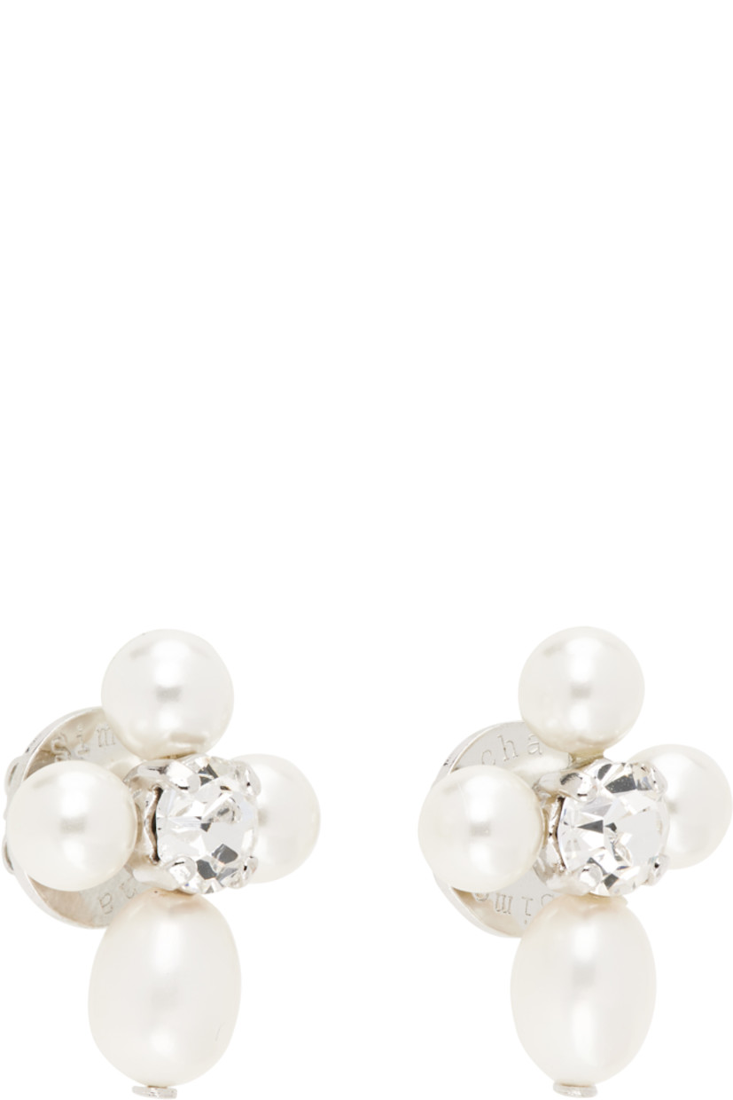 Pair of stud earrings in silver-tone brass.

· Freshwater pearls and prong-set glass crystal at face
· Post-stud fastening 
· H0.75" x W0.5"

Supplier color: Pearl/Crystal