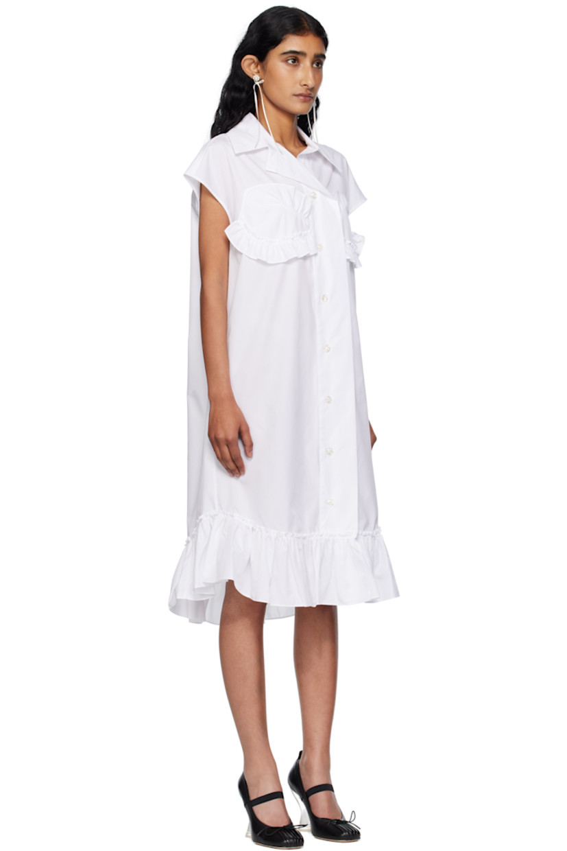 Cotton poplin midi dress.

· Spread collar
· Button closure with extended placket
· Ruffled trim at chest and hem
· Shirttail hem
· Box pleat at back yoke

Supplier color: White