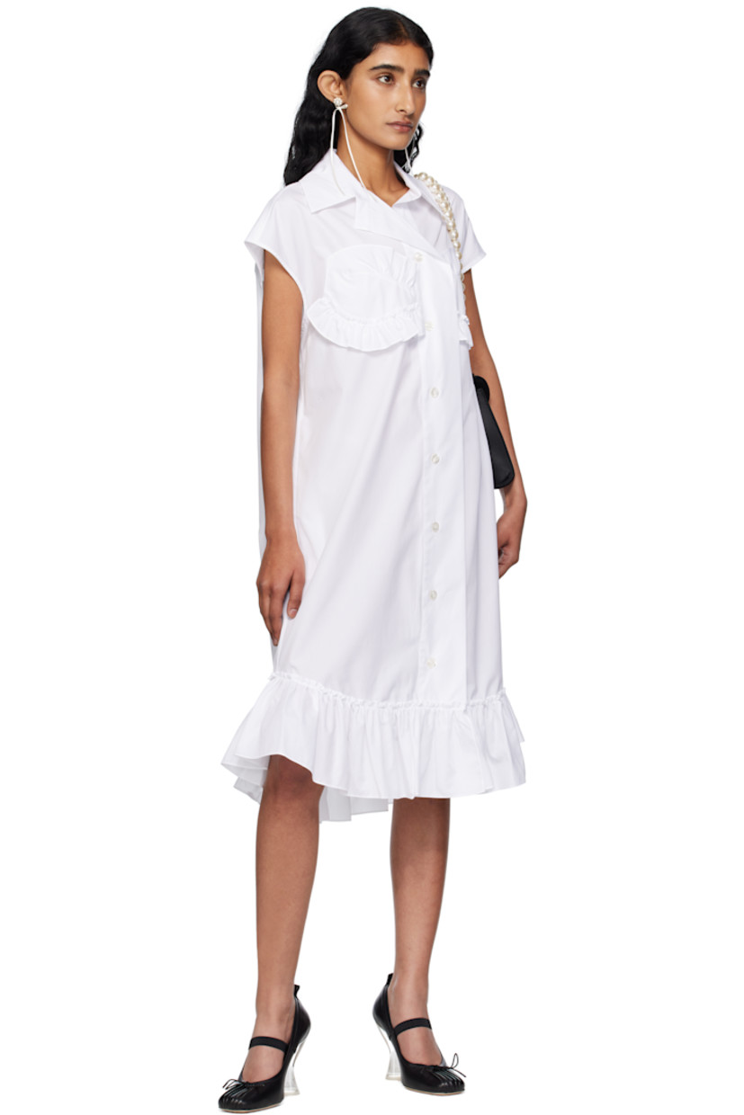 Cotton poplin midi dress.

· Spread collar
· Button closure with extended placket
· Ruffled trim at chest and hem
· Shirttail hem
· Box pleat at back yoke

Supplier color: White