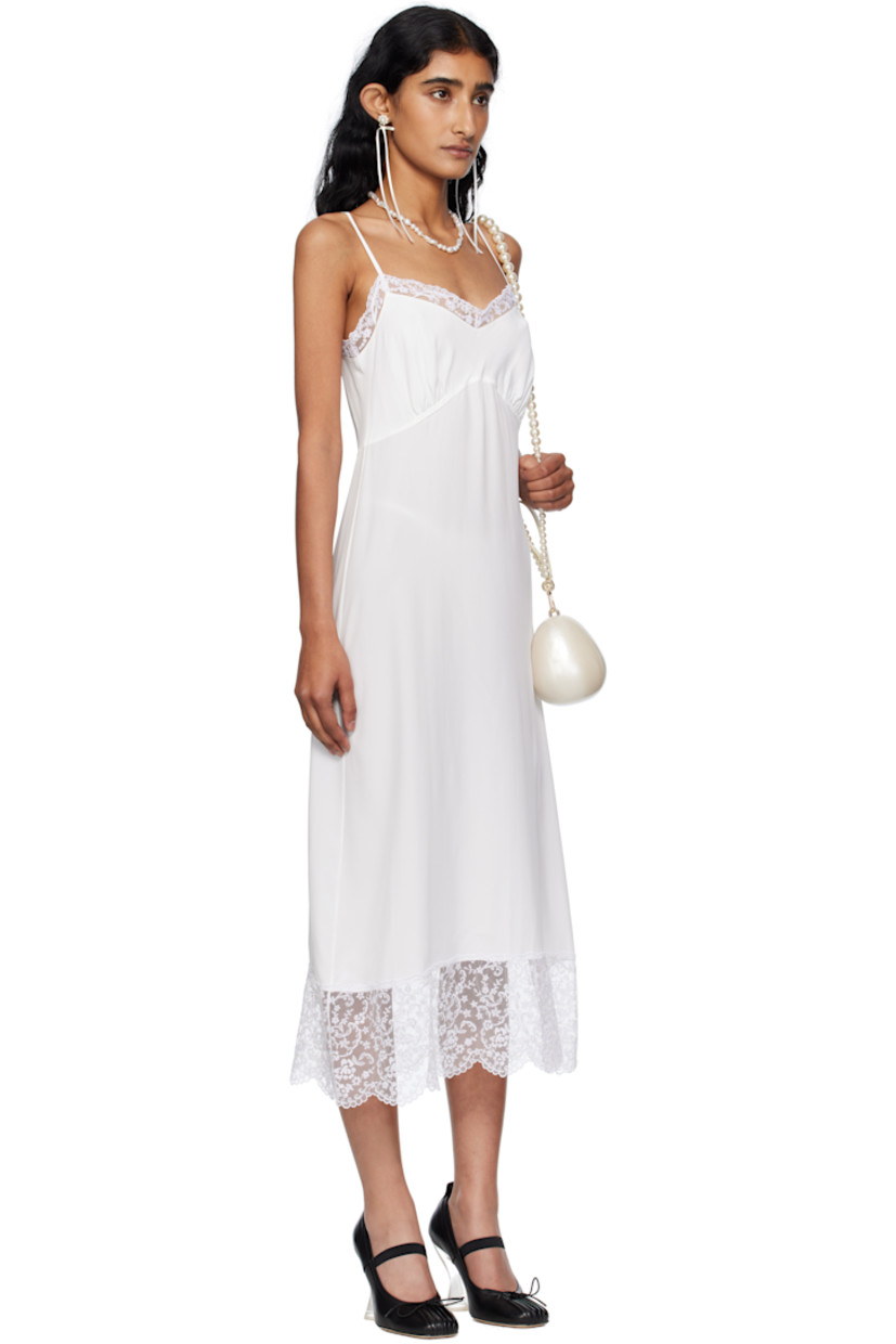 Semi-sheer crêpe de chine midi dress.

· Lace trim at sweetheart neck and hem
· Gathering at cups
· Adjustable spaghetti straps

Supplier color: Ivory