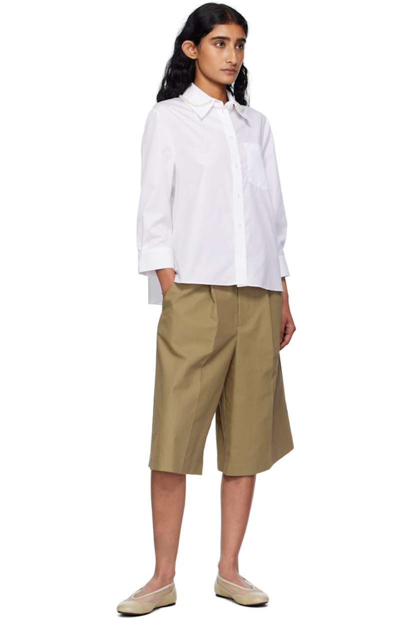 Cotton poplin shirt.

· Faux-pearl accents at spread collar
· Button closure
· Patch pocket at chest
· Cropped hem and sleeves
· Buttoned barrel cuffs
· Logo-engraved hardware

Supplier color: White/Pearl