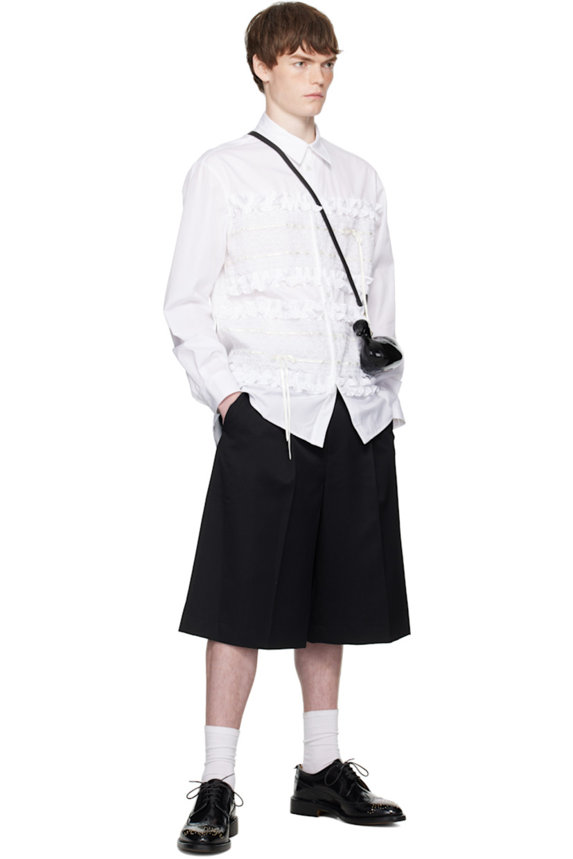 Cotton poplin shirt.

· Spread collar
· Button closure
· Ruffles, lace trim, and satin ribbons at front
· Shirttail hem
· Buttoned barrel cuffs
· Locker loop and box pleat at back yoke

Supplier color: White/Ivory