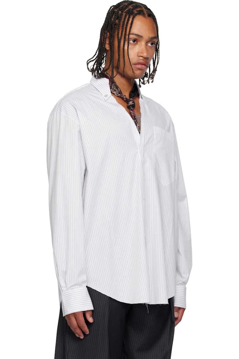 Cotton poplin shirt. 

· Stripes throughout 
· Modified button-down spread collar 
· Raw edges at V-neck and shirttail hem 
· Concealed button closure 
· Patch pocket at chest 
· Dropped shoulders 
· Pleats at buttoned barrel cuffs and back collar 

Supplier color: White