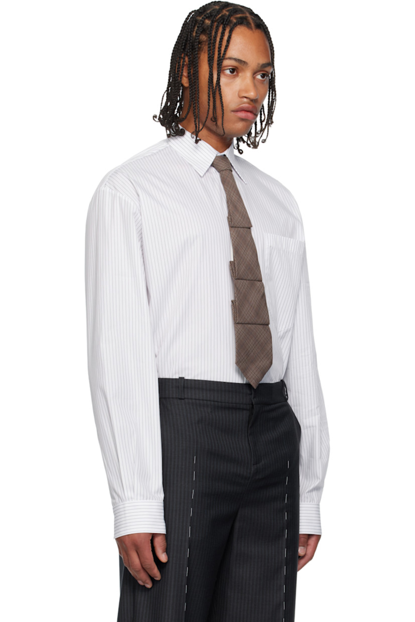 Cotton poplin shirt. 

· Pinstripes throughout 
· Spread collar 
· Concealed button closure 
· Patch pocket at chest
· Shirttail hem 
· Dropped shoulders 
· Pleats at buttoned barrel cuffs and back collar 

Supplier color: White