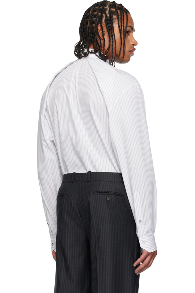 Cotton poplin shirt. 

· Pinstripes throughout 
· Spread collar 
· Concealed button closure 
· Patch pocket at chest
· Shirttail hem 
· Dropped shoulders 
· Pleats at buttoned barrel cuffs and back collar 

Supplier color: White