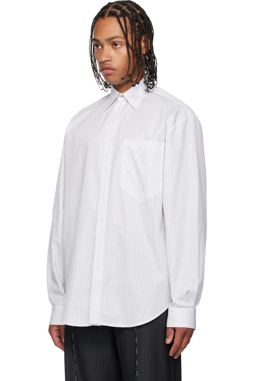 Cotton poplin shirt. 

· Pinstripes throughout 
· Spread collar 
· Concealed button closure 
· Patch pocket at chest
· Shirttail hem 
· Dropped shoulders 
· Pleats at buttoned barrel cuffs and back collar 

Supplier color: White