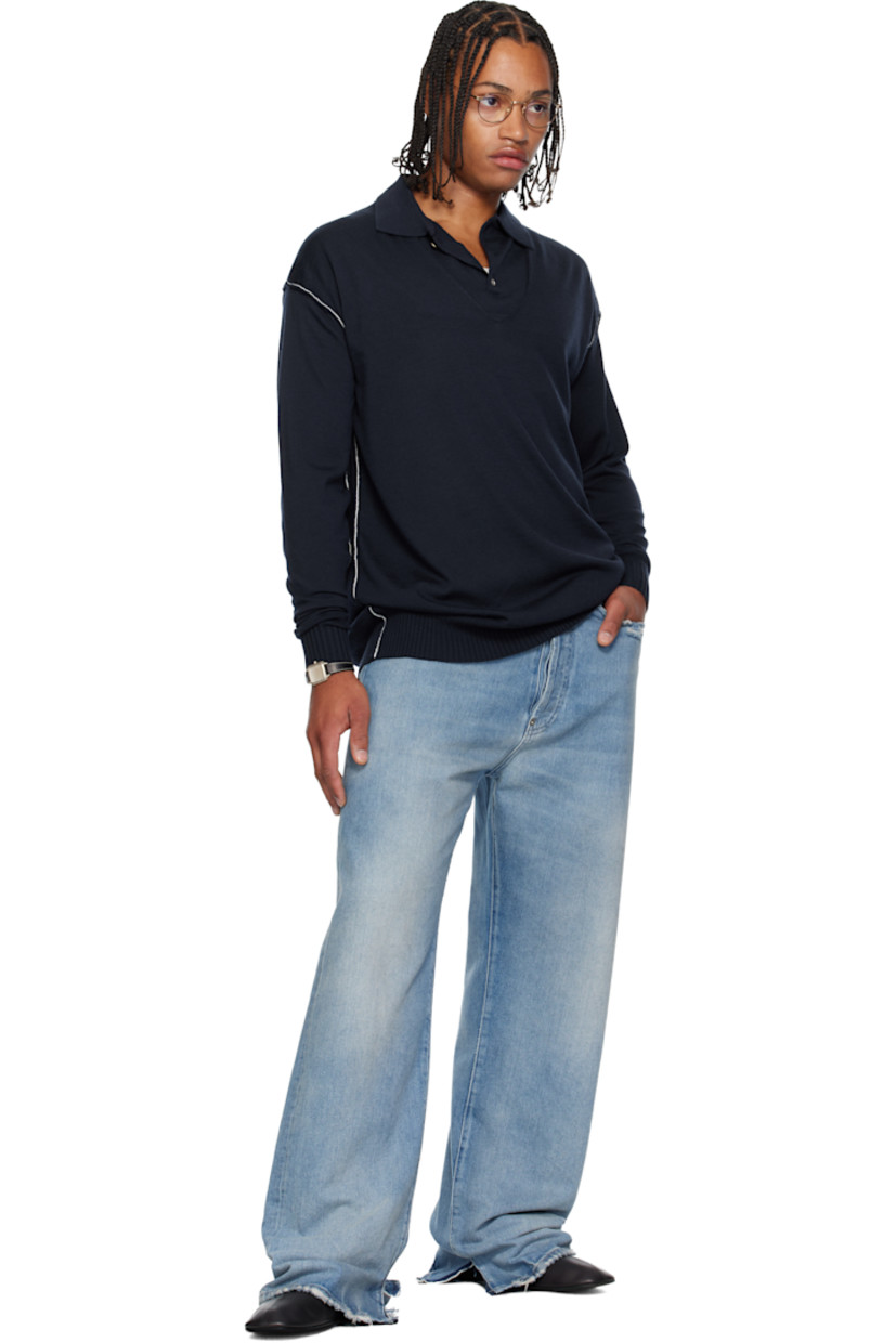 Knit virgin wool polo. 

· Layered construction
· Exposed seams throughout 
· Rib-knit spread collar, hem, and cuffs 
· Rolled edge at V-neck
· Three-button placket 
· Dropped shoulders
· Contrast stitching in white 

Supplier color: Navy