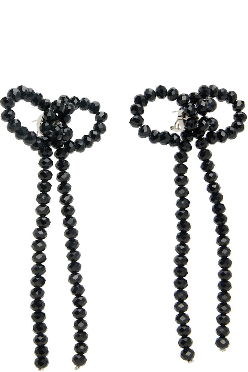 Pair of drop earrings in galvanized steel. 

· Beaded bow in black resin at face
· Silver-tone brass post-stud fastening 
· H5.5 x W2.5"

Supplier color: Black