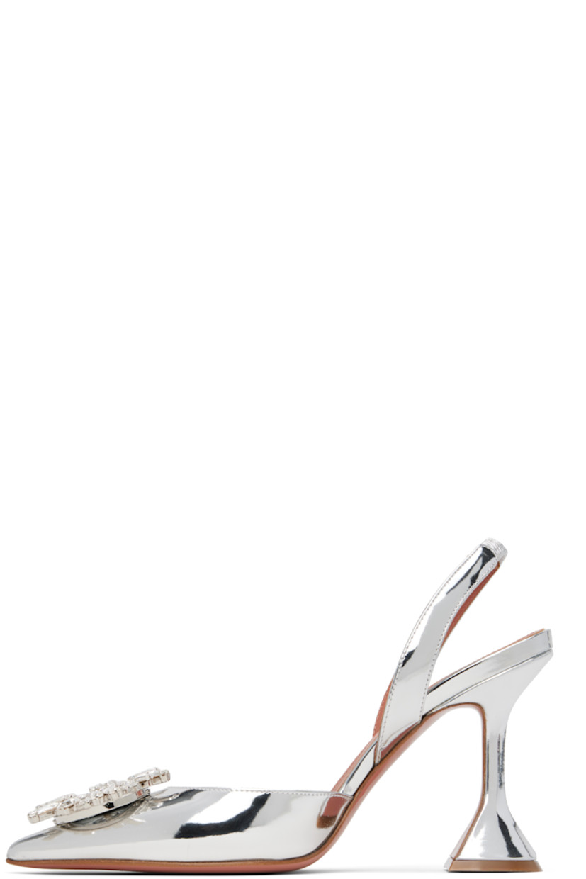 Patent calfskin heels in metallic silver tone. 

· Pointed toe
· Hardware with crystal-cut accents at vamp
· Partially elasticized slingback strap
· Logo-embossed goatskin footbed
· Covered spool heel with rubber injection
· Polished leather sole with rubber injection
· Heel: H3.75"

Supplier color: Silver mirror
