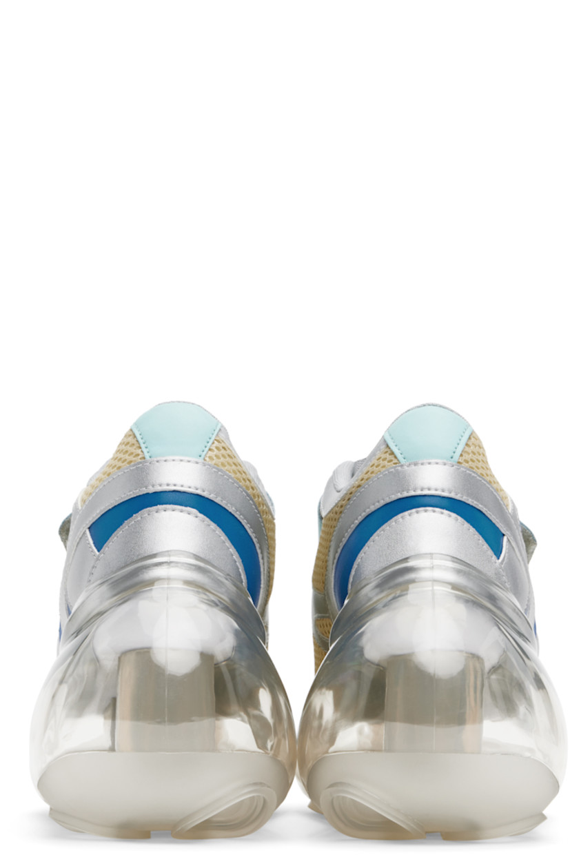 Low-top mesh and grained faux-leather sneakers in off-white, blue, and silver tone.

· Text printed at velcro closure
· Padded tongue and collar
· Graphic cutout at outer side
· Mesh lining
· Transparent rubber platform midsole
· Treaded rubber sole
· Platform: H2"
· Heel: H4"

Part of the I'm Sorry by Petra Collins x JennyFax collaboration.

Supplier color: Pastel
