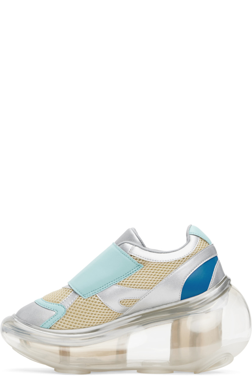 Low-top mesh and grained faux-leather sneakers in off-white, blue, and silver tone.

· Text printed at velcro closure
· Padded tongue and collar
· Graphic cutout at outer side
· Mesh lining
· Transparent rubber platform midsole
· Treaded rubber sole
· Platform: H2"
· Heel: H4"

Part of the I'm Sorry by Petra Collins x JennyFax collaboration.

Supplier color: Pastel