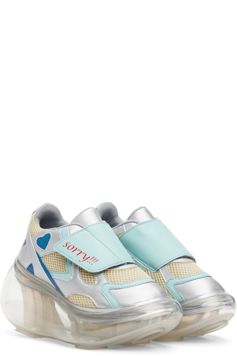 Low-top mesh and grained faux-leather sneakers in off-white, blue, and silver tone.

· Text printed at velcro closure
· Padded tongue and collar
· Graphic cutout at outer side
· Mesh lining
· Transparent rubber platform midsole
· Treaded rubber sole
· Platform: H2"
· Heel: H4"

Part of the I'm Sorry by Petra Collins x JennyFax collaboration.

Supplier color: Pastel
